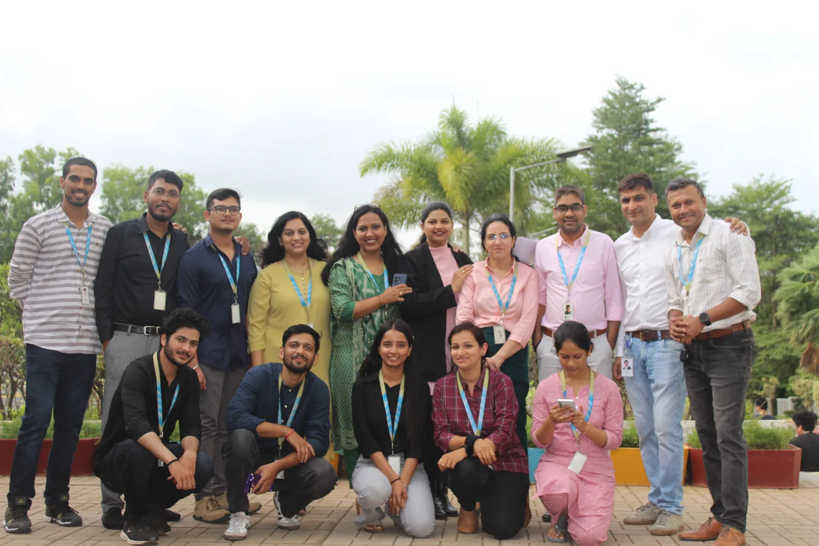 Group photo of the Capgemini team outdoors, two rows, everyone in lanyards